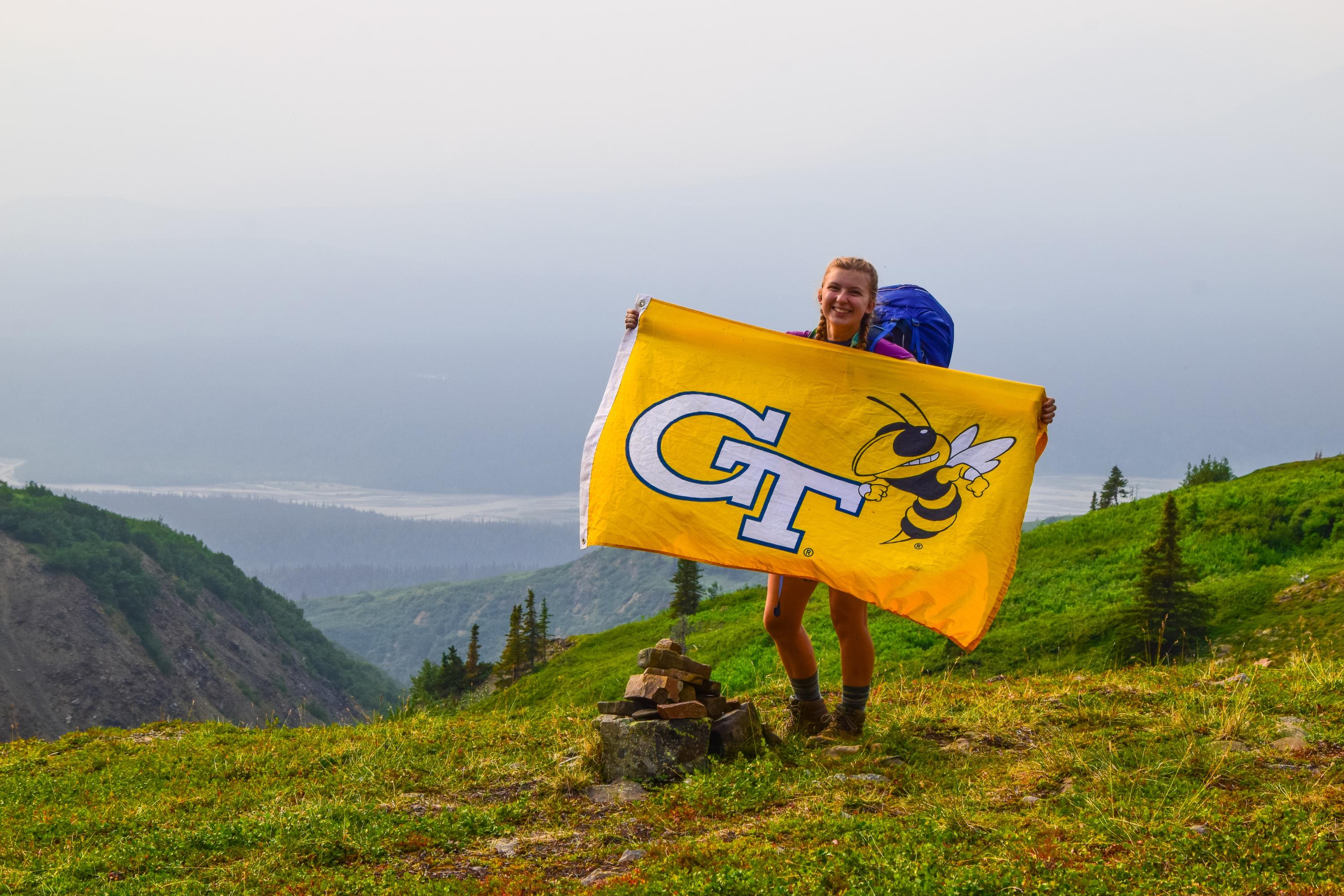 Mackenzie Sicard holds a GT flag on a recent expedition.