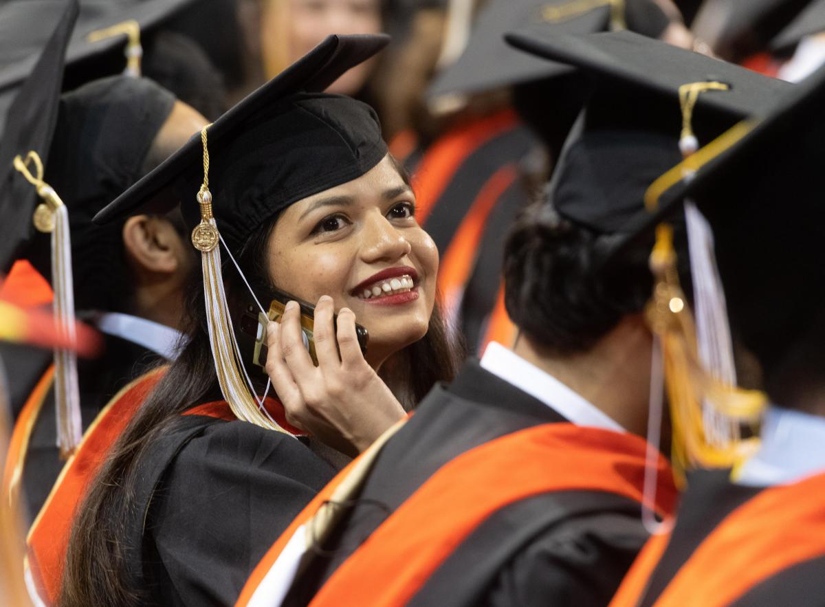 Student at graduation on the phone